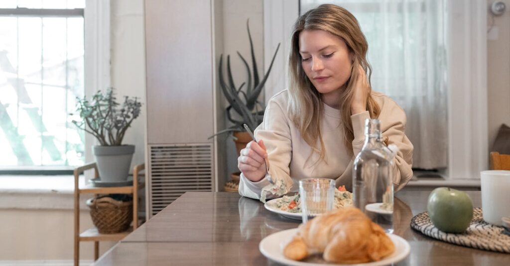 A woman indulging in a healthy salad at a cozy indoor setting, promoting wellness.
